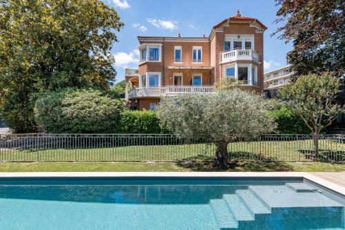 a house with a swimming pool in front of a house at Villa Elisa M in Aubenas
