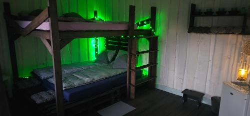 a room with two bunk beds with green lights at Lighthouse Benki in Užava