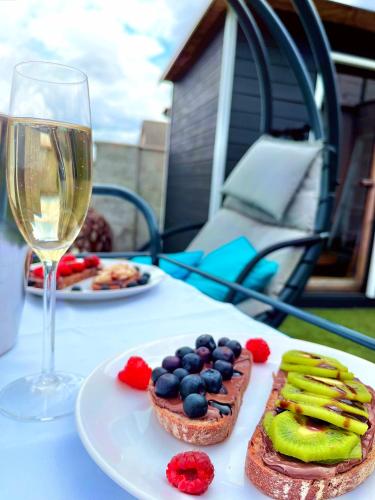 a table with a plate of food and a glass of wine at Villa46 in Pécs