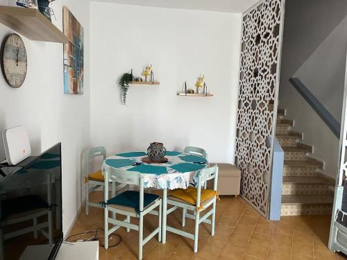 a dining room with a table and chairs and a staircase at Velazzura Marina- Duplex à Monastir in Monastir