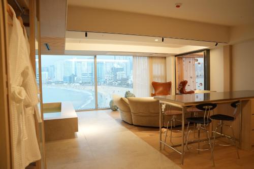 a kitchen and living room with a couch and a table at B'amu Hotel in Busan