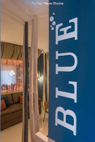 a blue sign in a room with a living room at Blue Perlage, Terre Marine in Vernazza