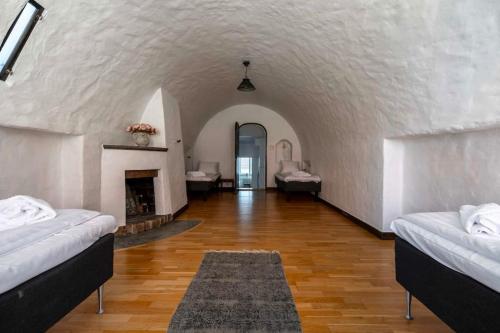a large room with two beds and a fireplace at Spacious and central 4BDR apartment in Visby