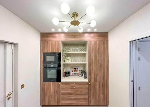 a kitchen with a wooden cabinet and a ceiling at Spacious LOFT with SPA - 4BR-8P - Montmartre in Paris