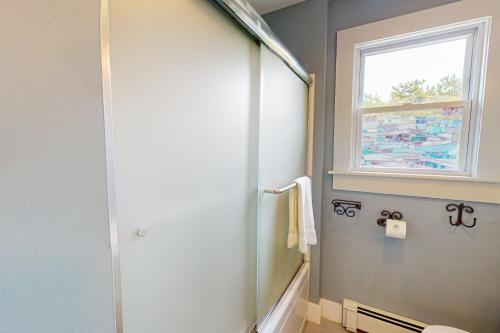 a bathroom with a window and a shower with a toilet at Bayview in Truro