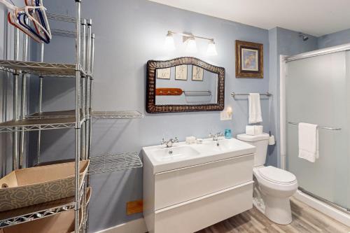 a bathroom with a sink and a toilet and a mirror at Bayview in Truro
