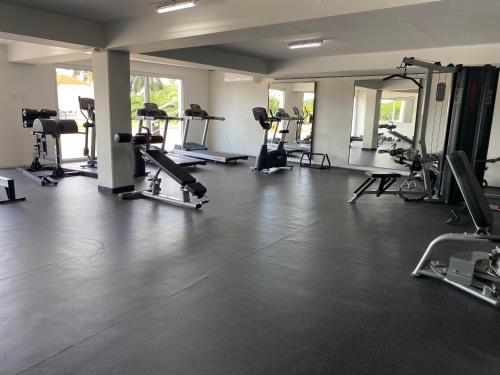 a gym with several treadmills and machines in a room at Ocean&airport view condo with pool&gym in Maho, walk to Maho Beach and Mullet Bay in Maho Reef