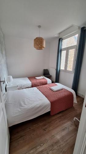 une chambre avec deux lits et une fenêtre dans l'établissement Chez Gabin, à Reims