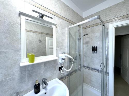 a bathroom with a sink and a shower at B&B CORSO ROMA Room Suite & Spa in Apricena