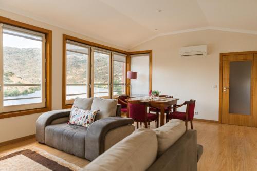 a living room with a couch and a table at Olhares do Douro in Torre de Moncorvo