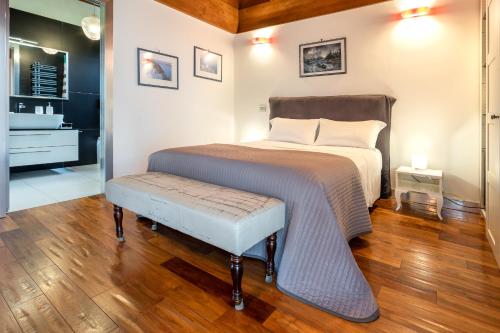 a bedroom with a bed with a bench next to it at Casale Delle Ronde B&B in Latina