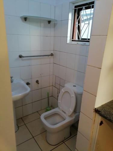 a bathroom with a toilet and a sink at 37 The trout Lodge in Cape Town