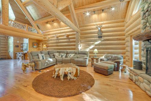 a living room with a couch and a fireplace at Lodge on 104 Acres with Fire Pit in Boyne City in Petoskey