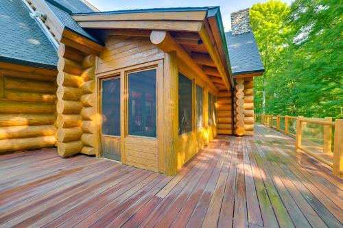 a log cabin with a large wooden deck at Lodge on 104 Acres with Fire Pit in Boyne City in Petoskey