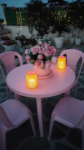 a pink table with two lights and flowers on it at Oasirelax -camera con vista a un passo da torino in Pavarolo