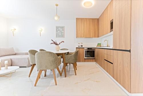 a kitchen and dining room with a table and chairs at Lush Suites in Trogir