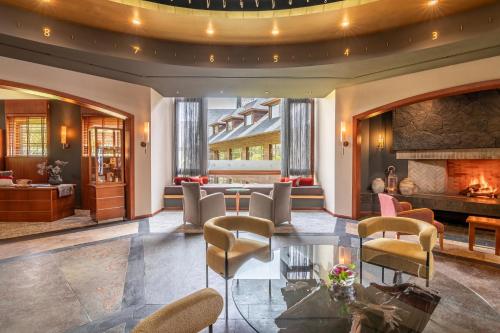 a lobby with chairs and a fireplace at Park Lake Luxury Hotel in Pucón