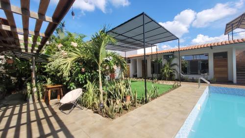 a villa with a swimming pool and a house at Posada Casa Bonita in Puerto Maldonado