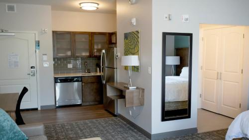 a room with a kitchen with a bed and a kitchen at Staybridge Suites Auburn Hills by IHG in Auburn Hills