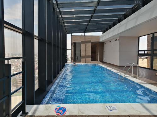 a swimming pool on the top of a building at Nice flat in financial heart of Bogotá in Bogotá