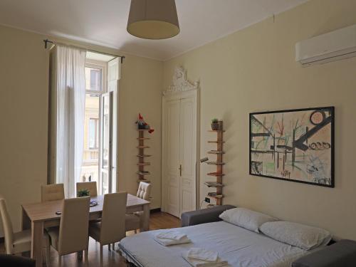 a living room with a couch and a table and a dining room at Inappartamento La Pepita Luxury in Turin