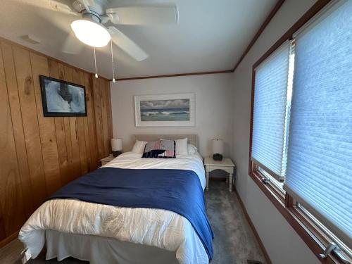 a bedroom with a bed and a large window at The Grey Goose in Duck