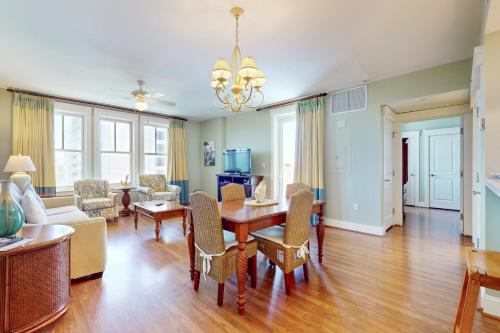 a living room with a wooden table and chairs at The Grand #2625 in Destin