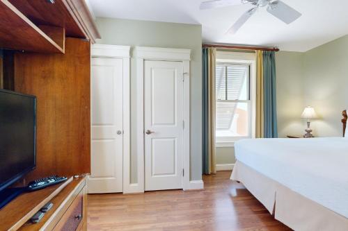 a bedroom with a bed and a flat screen tv at The Grand #2625 in Destin