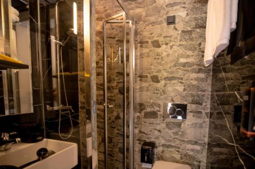 a bathroom with a shower and a sink at Sylvia Camping & Luxury Suites, Panel Hospitality Homes & Villas in Litochoro