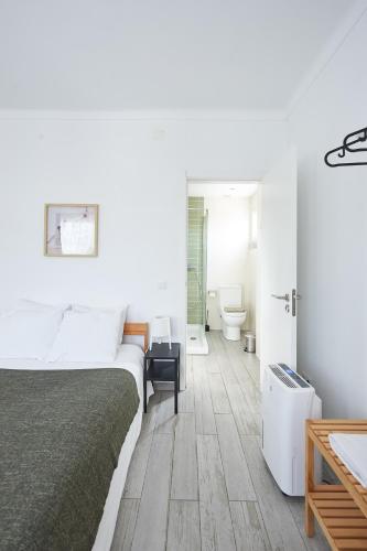 a bedroom with a bed and a bathroom with a toilet at Sintra Sweet Apartment II - Free Parking in Sintra