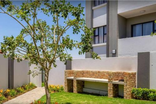 a brick bench in front of a building at 1 Bedroom Sleek, Spotless, Work-from-home Sanctuary in Midrand
