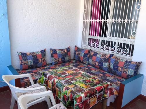 a living room with a couch and two chairs at Beachfront Bliss in Martil