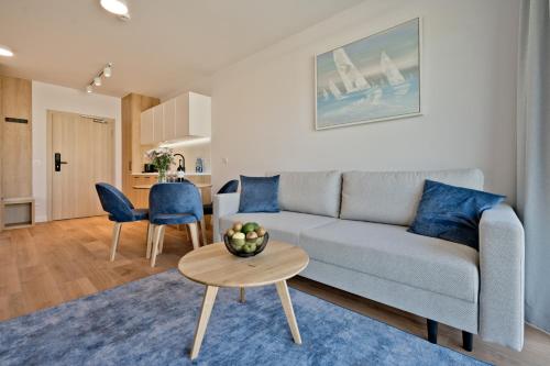 a living room with a couch and a table at Aparthotel Anchoria BlueApart in Mechelinki