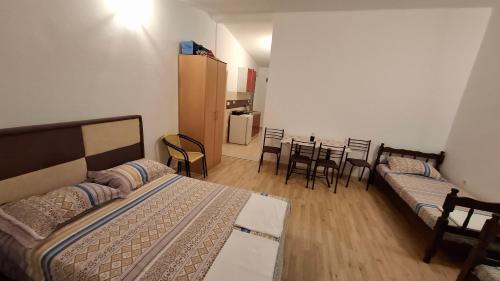 a bedroom with two beds and a table and chairs at Apartment Djokic in Sutomore