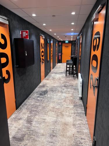 a hallway with orange and black walls at Beach House Ystad in Ystad