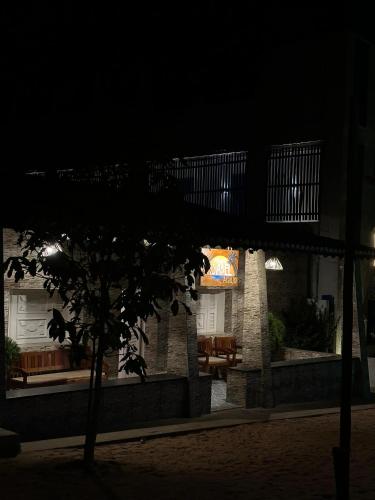 a building with a sign on it at night at Pousada Isabel Araújo in Jericoacoara