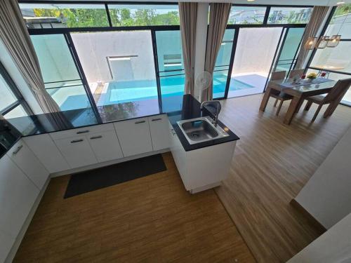 a room with a sink and a table in a building at The Joy Private Pool Villa in Chiang Mai