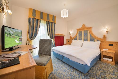 Ένα ή περισσότερα κρεβάτια σε δωμάτιο στο Hotel Cristallo