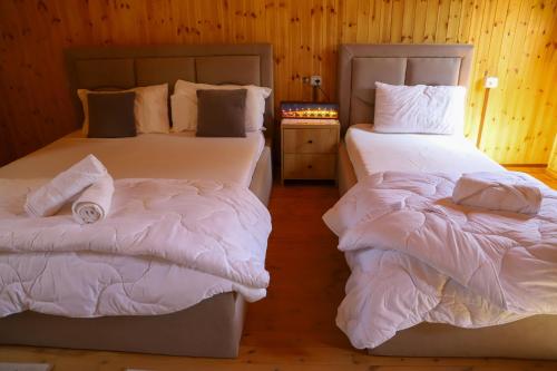 two beds sitting next to each other in a room at Wood House Berat in Berat