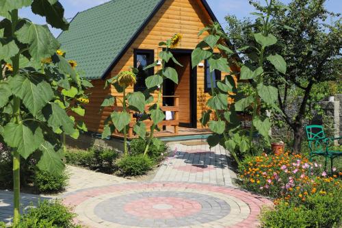 a log cabin with a garden in front of it at Wood House Berat in Berat
