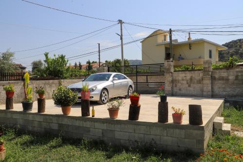 a car parked in a driveway with potted plants at Wood House Berat in Berat