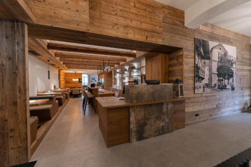 a restaurant with wooden walls and tables and chairs at Kirchenwirt Wörgl in Wörgl