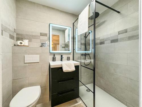 a bathroom with a toilet and a sink and a shower at Élégance au Cœur de Tarbes in Tarbes
