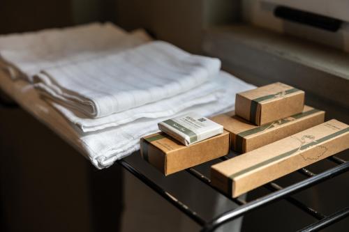 a table with three boxes and towels on it at Cristal Palace Hotel in Andria