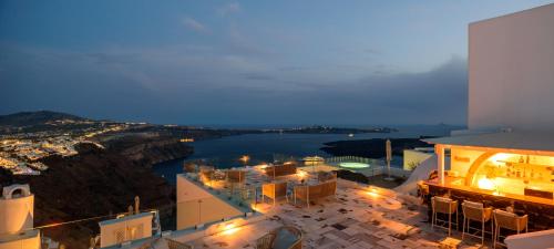a view of a city at night with lights at MyBoZer Hotel Kallisto in Imerovigli