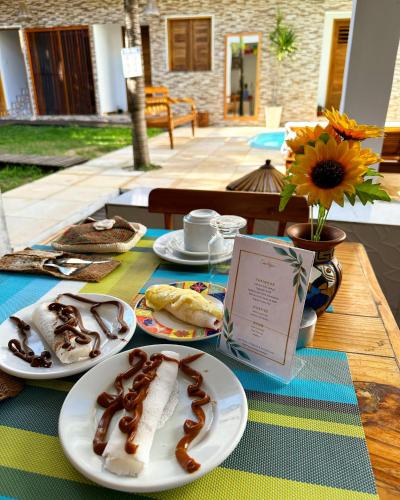 a table with plates of food on top of it at Pousada Isabel Araújo in Jericoacoara