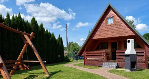 a small cabin with a large window on the side at Domki nad Soliną - Bieszczadzka Osada 512-823-385 in Solina