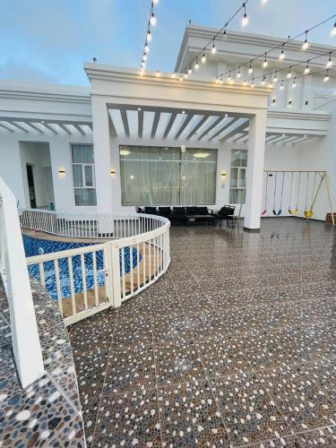 a large room with a lobby with a dance floor at ALHakim chalet in Arzat
