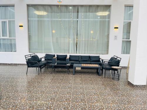 a group of chairs and a table in a room at ALHakim chalet in Arzat
