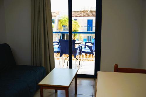 a living room with a couch and a table at Green Bungalows Hotel Apartments in Ayia Napa